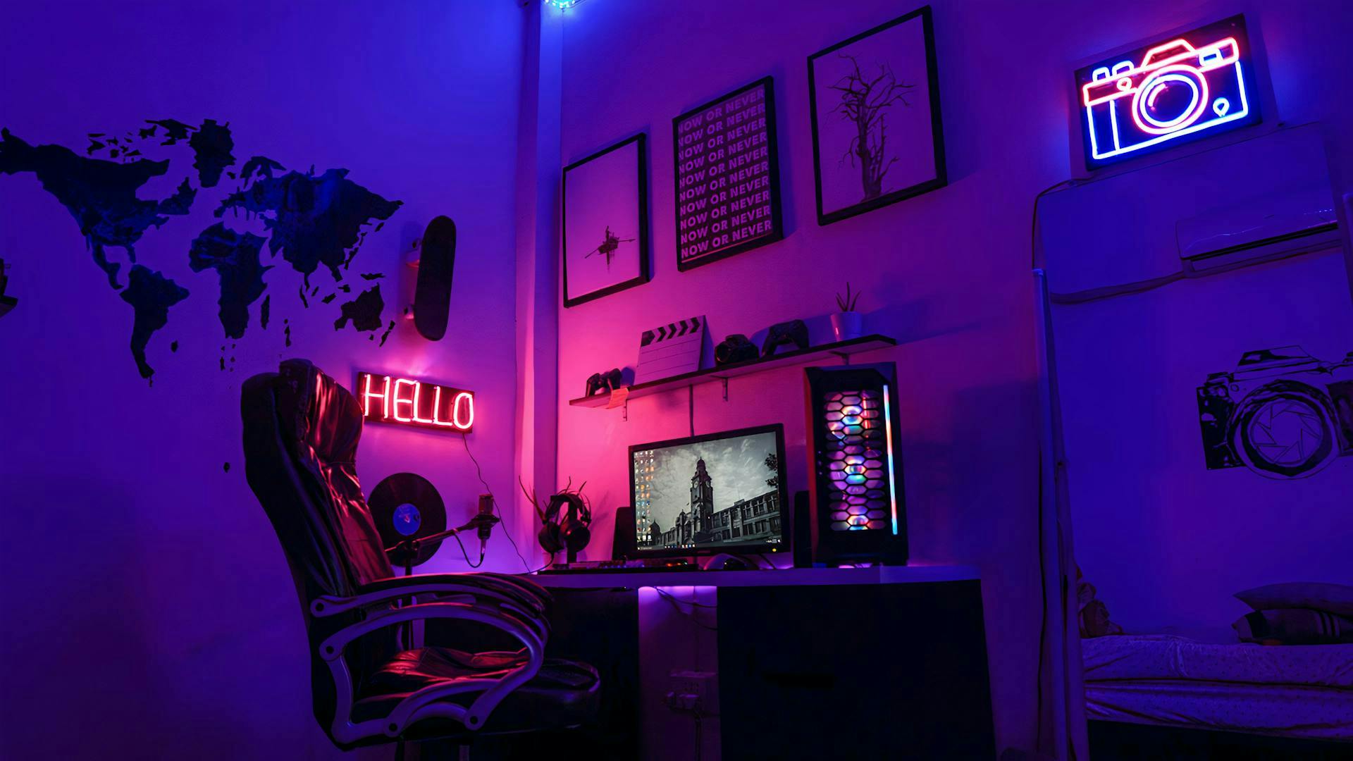 In an elaborately decorated gaming setup with blue and purple illuminated LED and gaming lights, an LED gaming PC stands amidst lots of gaming decorations