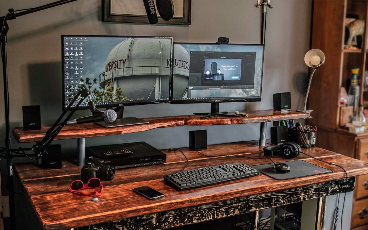 A multi-tiered gaming desk with a wood look | Credit: Reddit user "gartleby"
