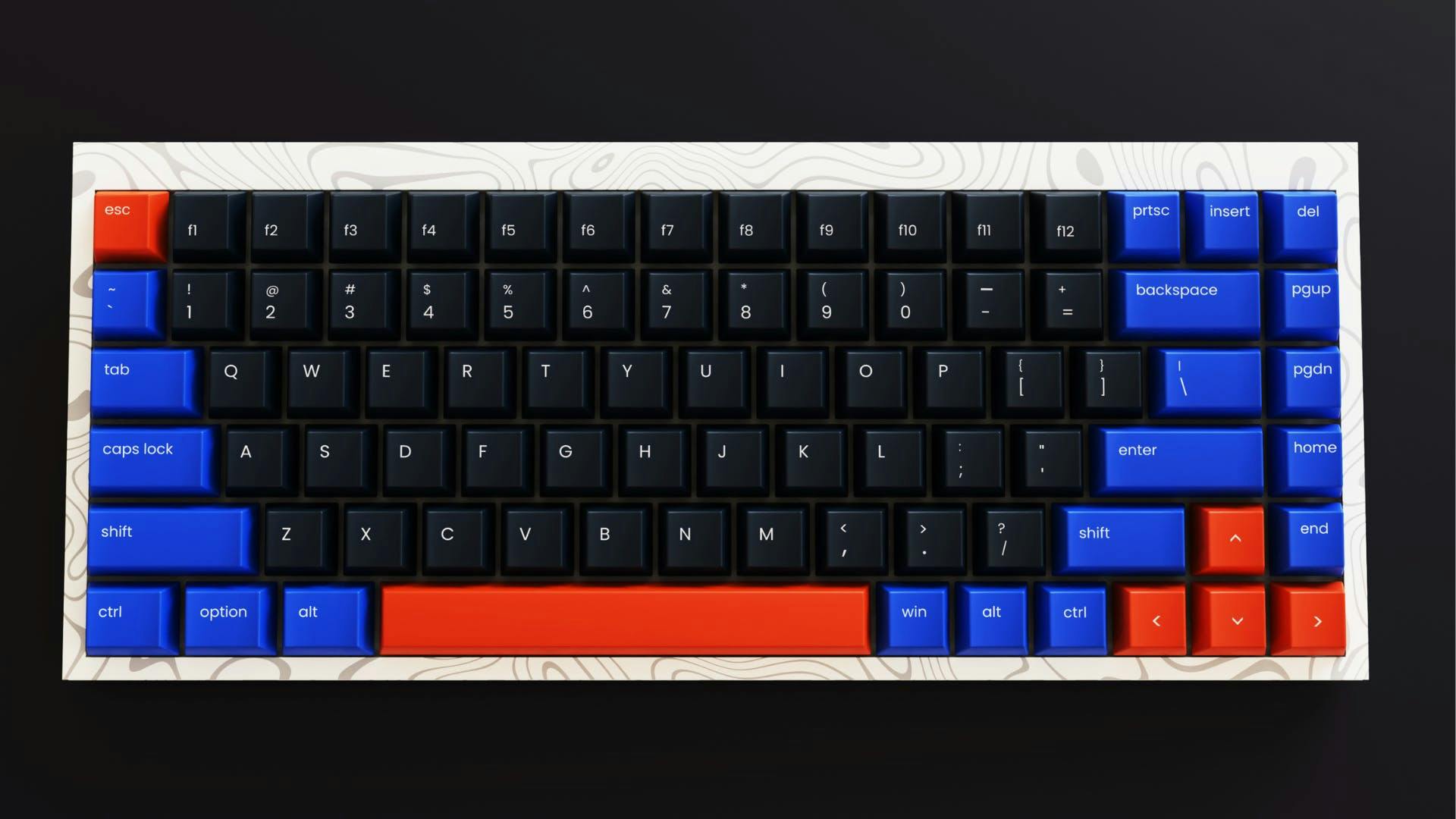 A gaming keyboard without a number pad and partially red and blue coloured keys