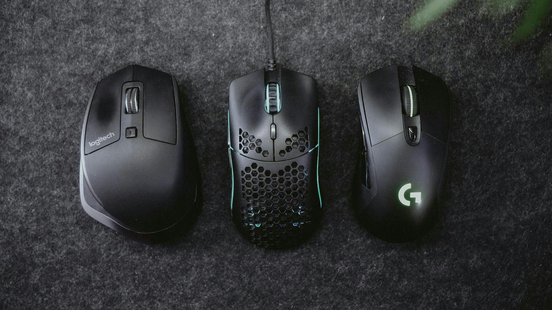 Three gaming mice from different manufacturers lie side by side